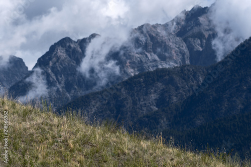 Morning mist rises above the Fairmont Ridge mountain peaks in British Columbia