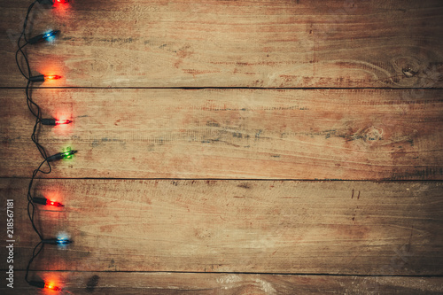 Vintage Christmas lights bulb decoration on old wood plank. Merry Christmas and New Year holiday background. vintage color tone.