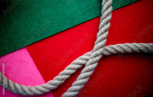 Rope on multicolored red green pink background