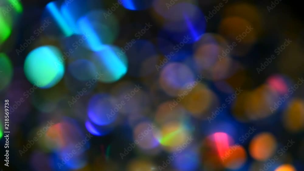Defocused shimmering multicolored glitter confetti, black background. Party, magic, imagination. Rainbow colors, sparkle circles. Holiday abstract festive texture of shiny blurred bokeh light spots. Defocused shimmering multicolored glitter confetti, black background. Party, magic, imagination. Rainbow colors, sparkle circles. Holiday abstract festive texture of shiny blurred bokeh light spots.