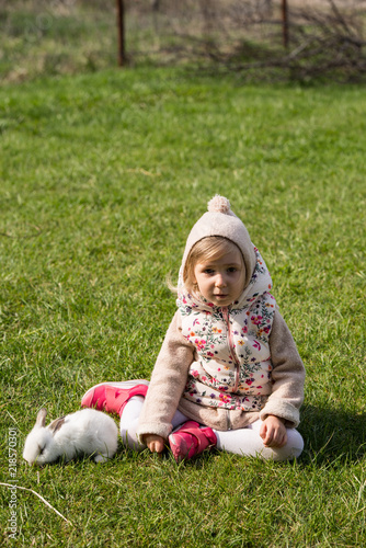 Girl sitting in gardenn with her bunny photo