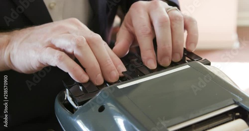 Stenographer or court reporter typing out short hand using a stenograph or steno writer machine. photo