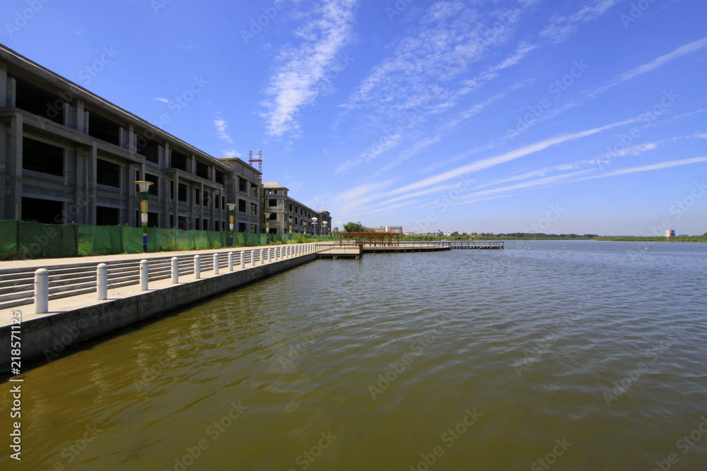 Fototapeta premium Wide water surface and high rise buildings