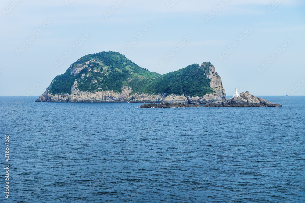 Island Hoenggando-gil with white lighthouse seen from ferry from Jeju to Mokpo, South Korea