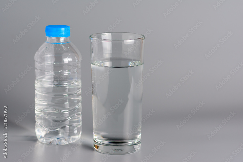 Glass with water on a white table.. Glass with water on a white table..