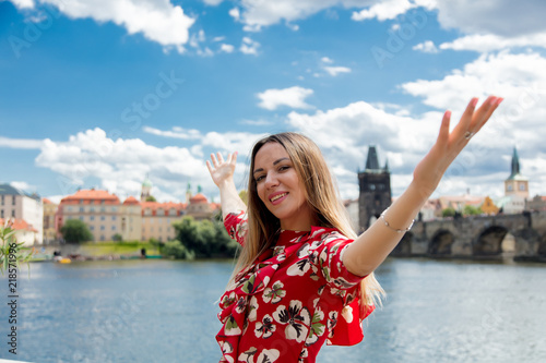 Photography Beautiful girl in red dress travel in Prague, city streets