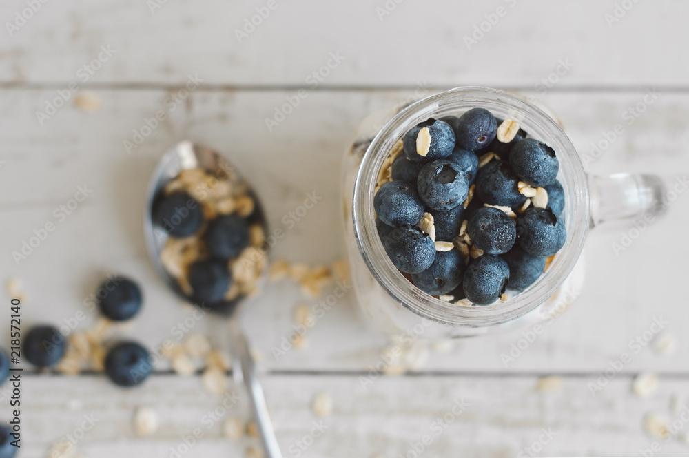 Overnight oats with whole grain cereal and blueberry and spoon with