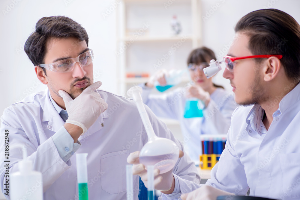 Team of chemists working in the lab Team of chemists working in the lab