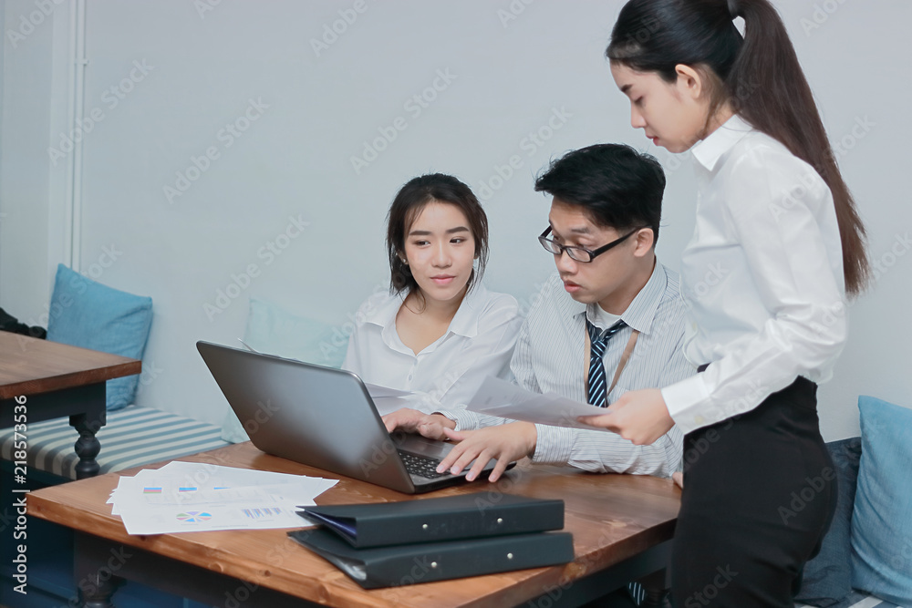 Teamwork business concept. Group of Asian people working with laptop together in modern office. Selective focus and shallow depth of field.