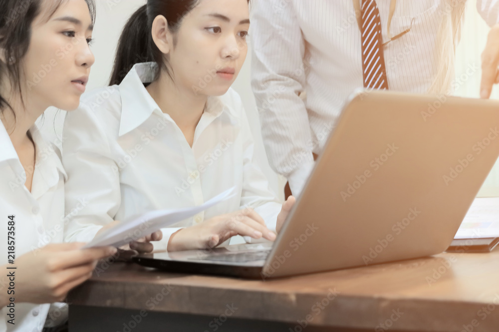 Teamwork business concept. Group of Asian people working with laptop together in modern office. Selective focus and shallow depth of field. Teamwork business concept. Group of Asian people working with laptop together in modern office. Selective focus and shallow depth of field.