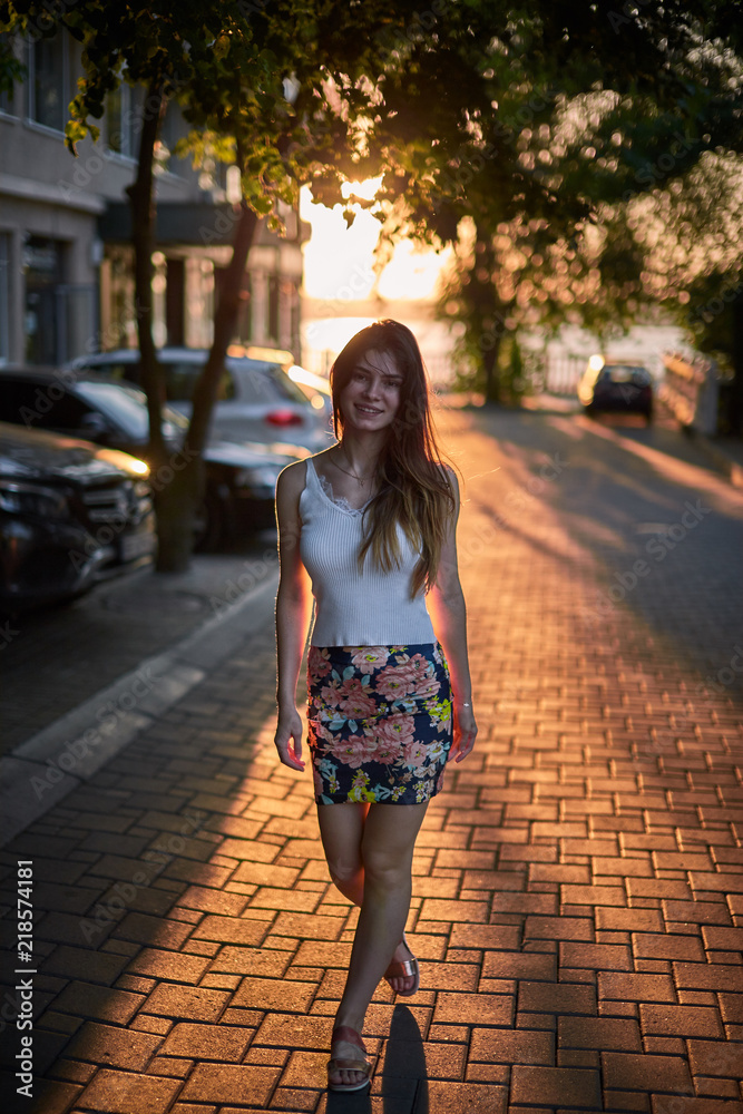 Street photo of young beautiful girl during sunset