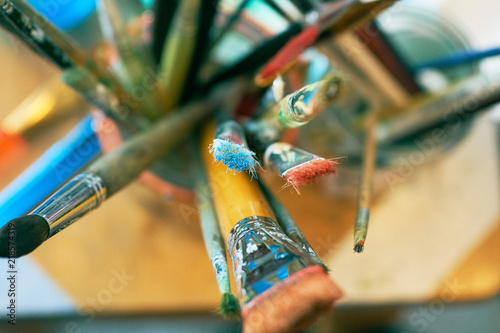 Close up of different painting brushes in paiter's atelier. Top view.