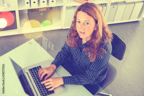 brown-haired  blond businesswoman with computer photo