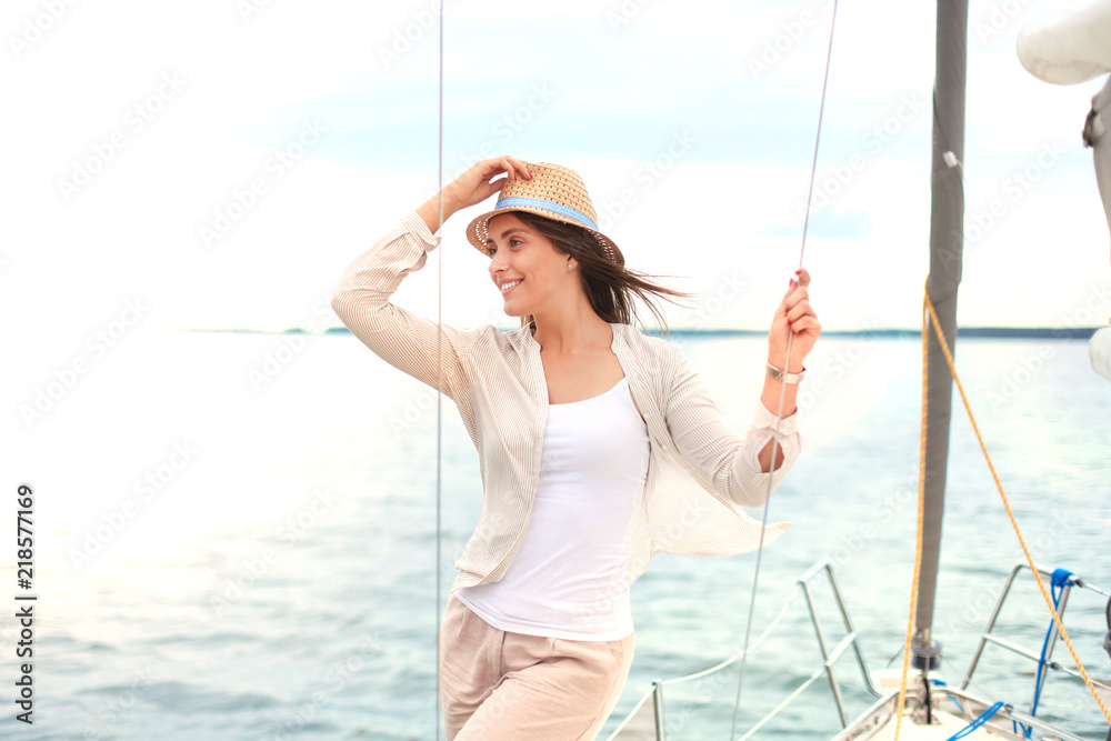Relaxing attractive young woman on vacation standing on yacht. Relaxing attractive young woman on vacation standing on yacht.