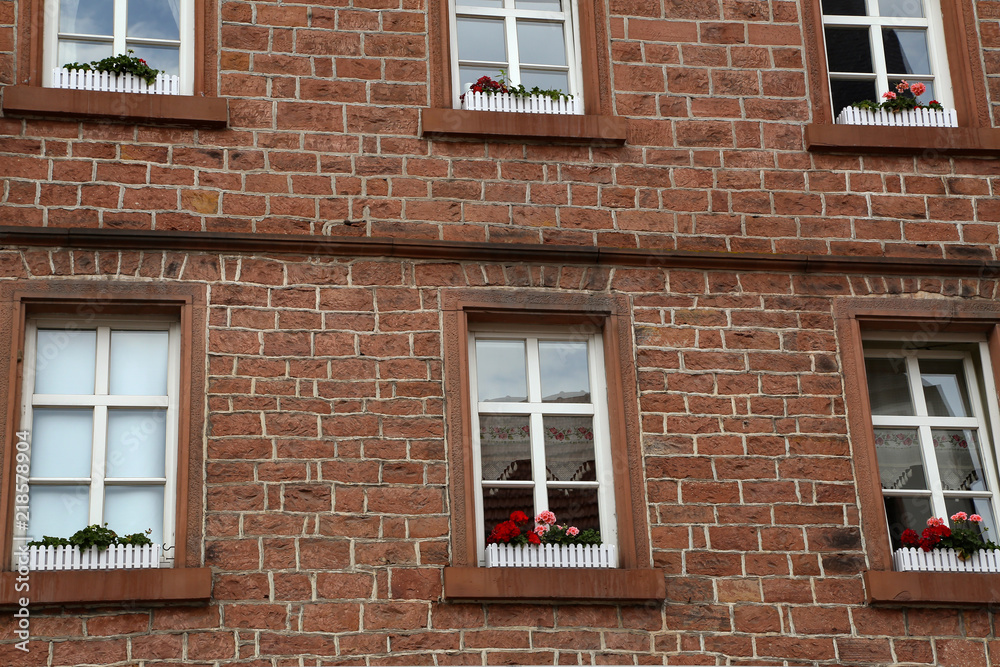 Brick wall of a house with windows Brick wall of a house with windows