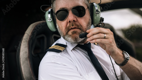 Mature helicopter pilot with headset photo
