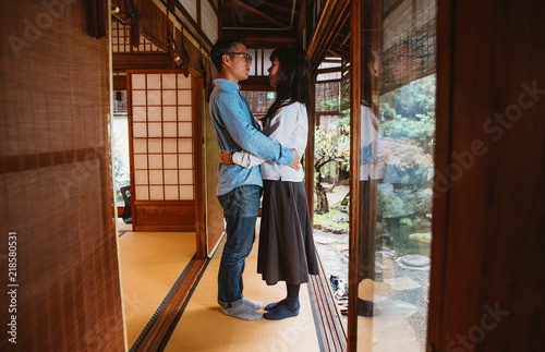 Young japanese couple spending time in their house