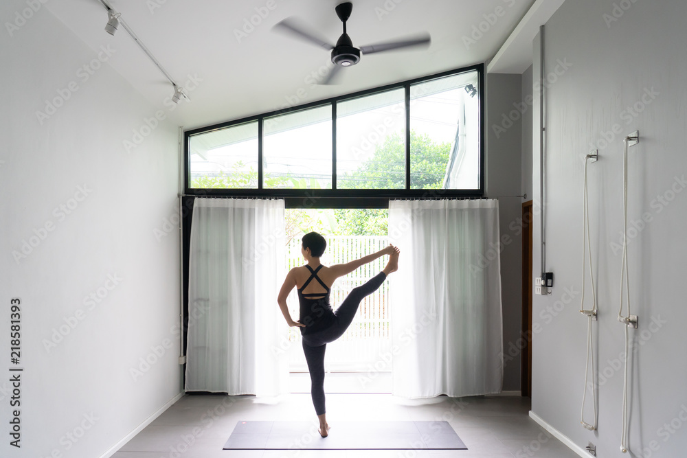 Asian young woman practicing yoga in gray background.Young people do yoga indoor. Asian young woman practicing yoga in gray background.Young people do yoga indoor.