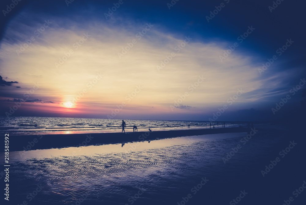 Obraz premium Nature in twilight period which including of sunrise over the sea and the nice beach. Summer beach with blue water and purple sky at the sunset.