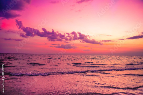 Nature in twilight period which including of sunrise over the sea and the nice beach. Summer beach with blue water and purple sky at the sunset.