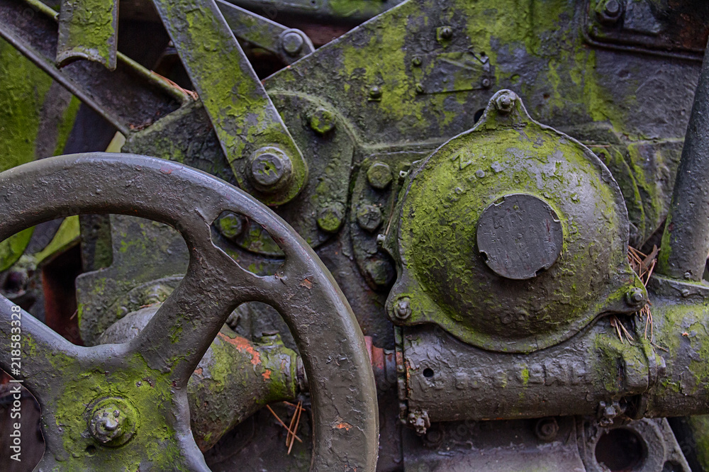 Old, rusty and covered with green patina, fragments of old machines, wheels, handles. Old, rusty and covered with green patina, fragments of old machines, wheels, handles.
