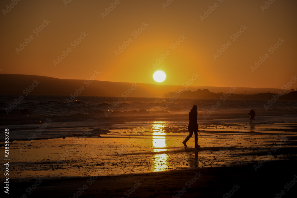 People on the beach  at sunset in  Silhouette