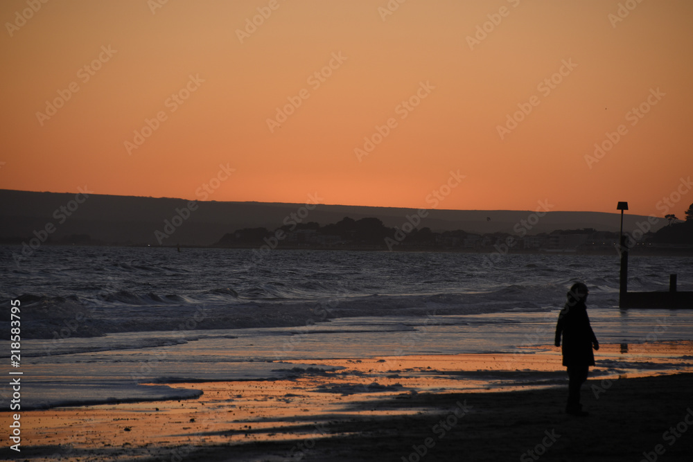 Person on the beach at sunset