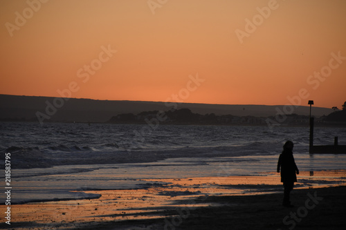 Person on the beach at sunset