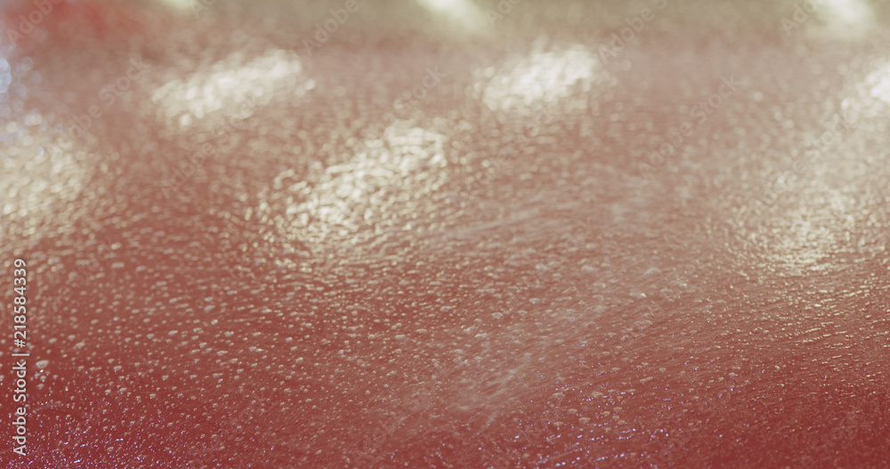 Fototapeta premium closeup of spaying soapy water on car before applying protective film