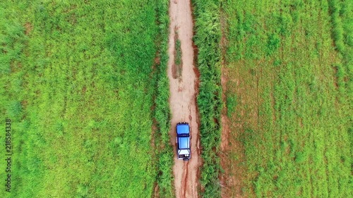 Aerial view of blue car driving on mountain road in Thailand.Drone shot flying.