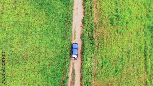 Aerial view of blue car driving on mountain road in Thailand.Drone shot flying.