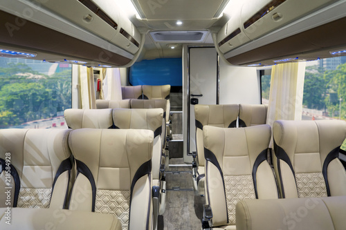 Luxury bus interior with comfortable seats © Creativa Images