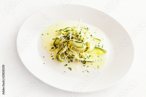 zucchini strips with creamy alfredo sauce sprinkled with chopped parsley and parmesan