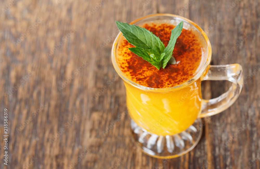 Healthy pumpkin fruit smoothie with seeds and mint leaves on table Healthy pumpkin fruit smoothie with seeds and mint leaves on table
