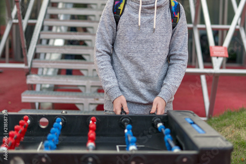 Photography young man playing tablefootball in park in moscow