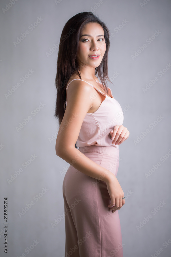 Asia beautiful woman wear sweet pink dress pants. Standing in front of a white background. Asia beautiful woman wear sweet pink dress pants. Standing in front of a white background.