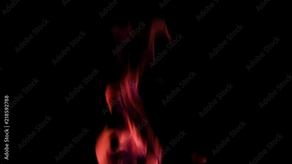 Close up fire burning in the fireplace. Video of fire flames over dark background Close up fire burning in the fireplace. Video of fire flames over dark background