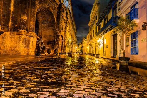 Night travel photography in Havana, Cuba. The colonial architecture of Havana. Limestone paved streets glowing in the night. © Vlad Ispas