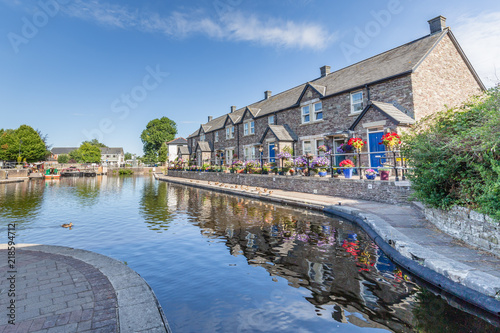 Cottages reflecting in the water of  Brecon Canal basin  in Brecon town, Brecon Beacons National Park, Wales, UK photo