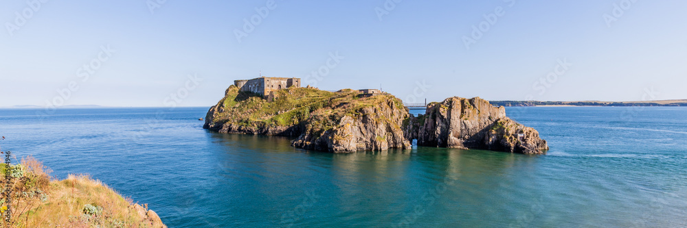 Panoroma of Saint Catherine's island and fort at the coast of Tenby on a hot summer day, Wales, UK. A picturesque and colorful village on the coast of Wales.