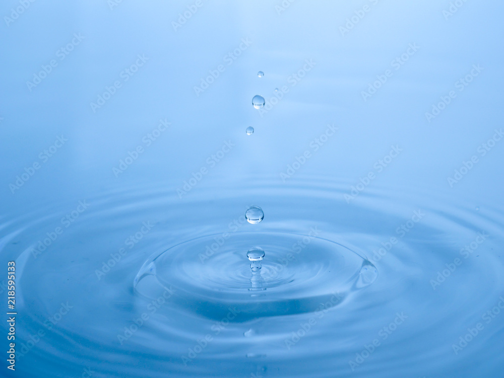 close up drop of water on blue background close up drop of water on blue background