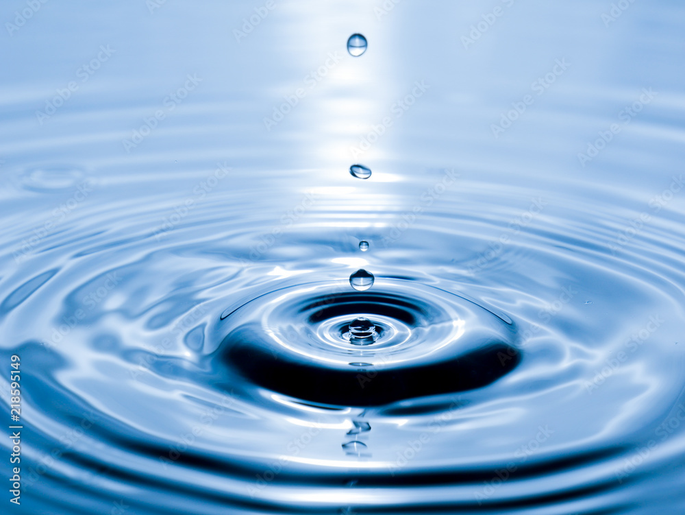 close up drop of water on blue background close up drop of water on blue background