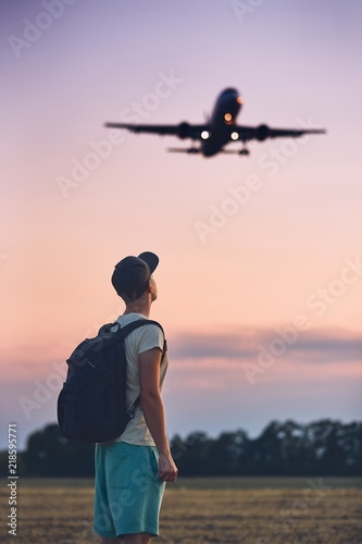 Traveler is looking at the landing airplane
