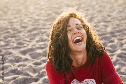 Fototapeta bright picture of laughing woman on the beach
