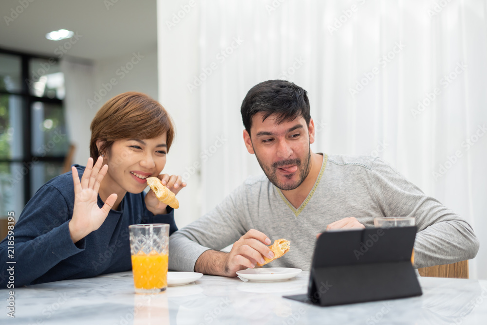 Young couple waving hands and making video call. Young couple waving hands and making video call.