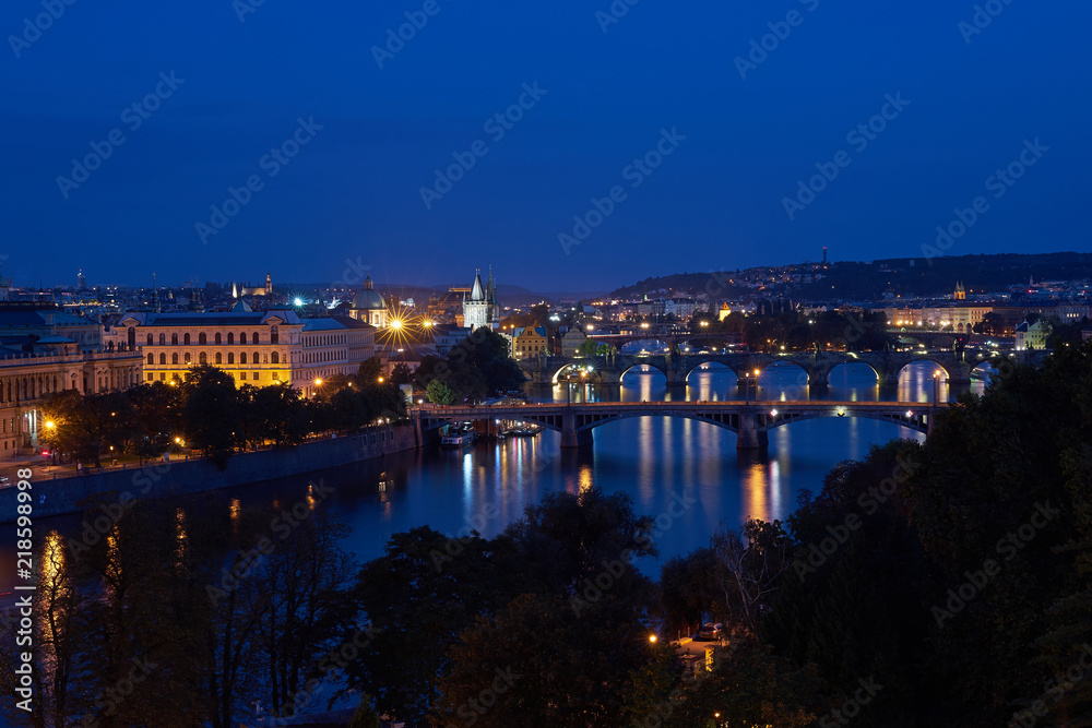 Night landscape or cityscape Picture of bridges over the Vltava river in the  old historical city centre or downtown of Prague, capitol of Czech Republic, Europe. 