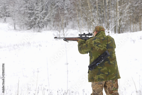 hunter prepare for shot from sniper carbine with optical sight