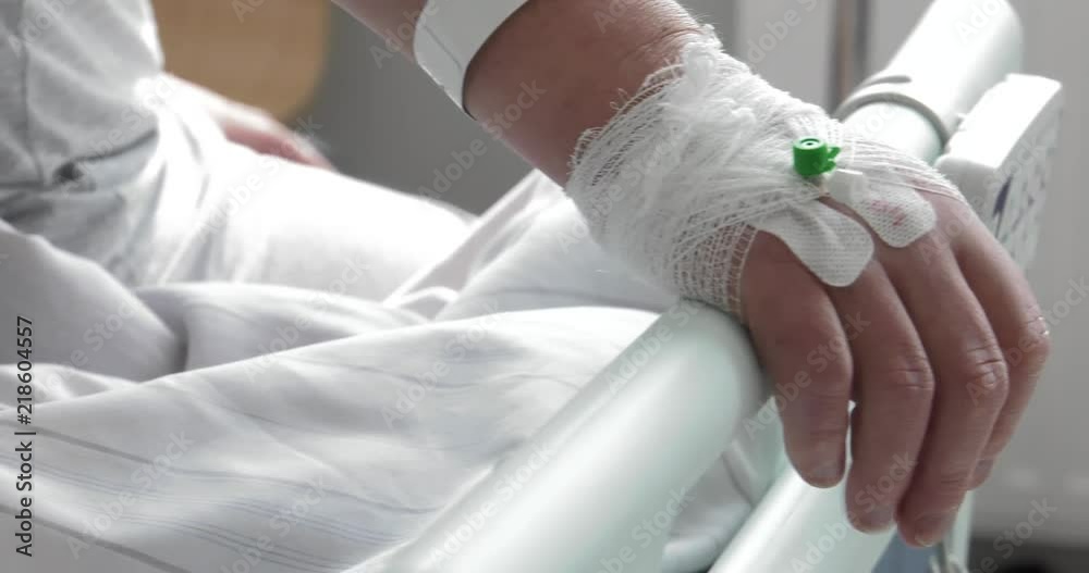 Patient in the hospital has a central puncture (catheter). Elderly man