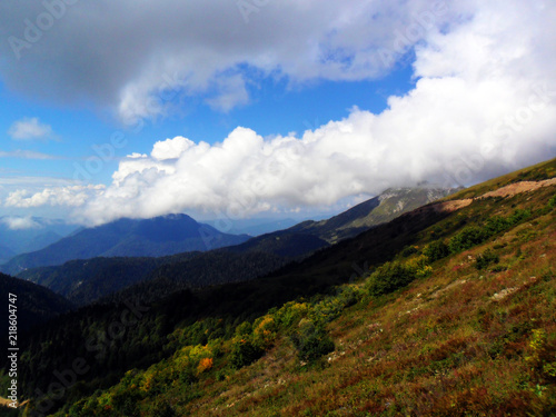 Mountain landscape with clouds and sun