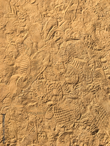 Many footprint on the sand beach texture background. © sukanda